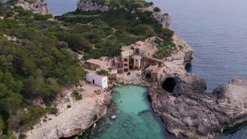 Aerial view of cove with turquoise water and cliffs, Spain.
