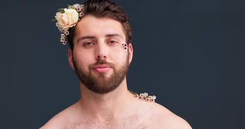 Flowers, self confidence and skincare with face of man in studio for acceptance, natural and pride