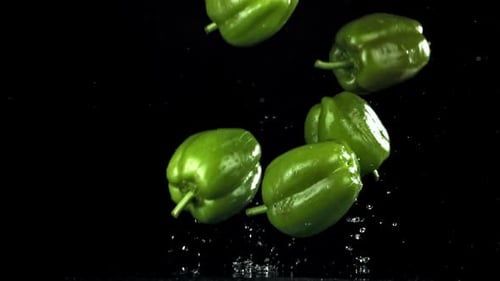 Bright Green Peppers Splash As They Tumble with Energy Filmed on a Highspeed Camera at 1000 Fps