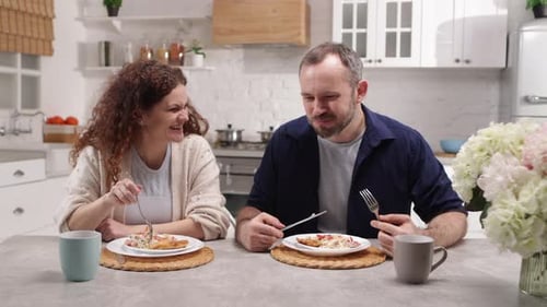 Couple Enjoying Lunch Together in Bright Kitchen