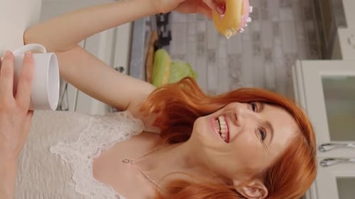Young Adult Woman Holds Donut and Mug