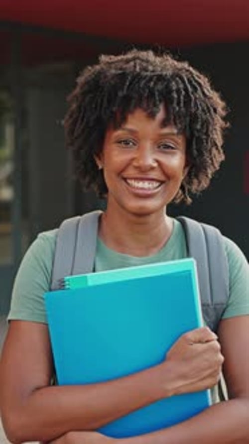 Young Adult Student Smiling and Holding Books