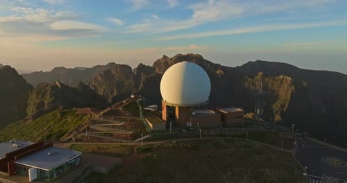 Dome Shaped Structure on Mountain at Sunrise