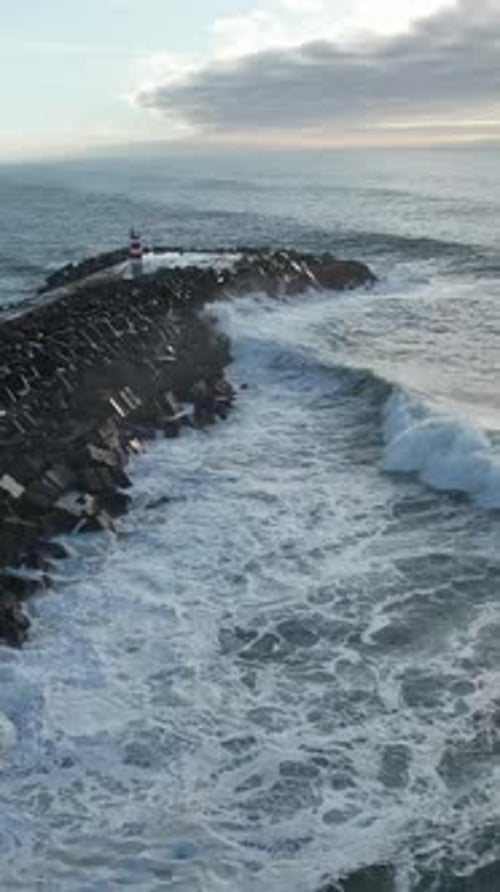 Vertical Video of Big Waves Crashing on the Pier on Storm Day