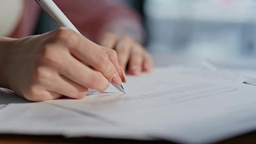 Customer Hand Signing Deal of Real Estate Purchase in Company Office Closeup