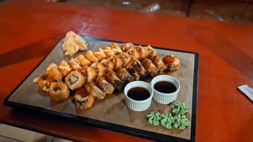 Delicious fresh sushi plate on wooden table, zoom in view