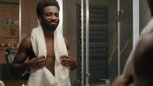 Man Checking Himself Out in Bathroom Mirror