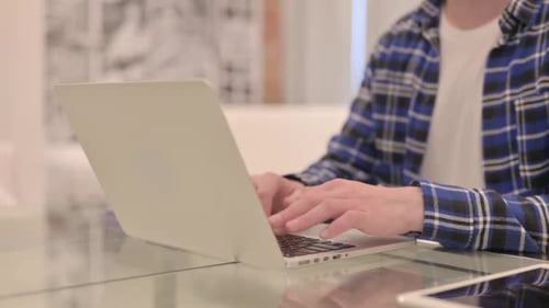 Close Up of Man Typing on Laptop