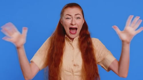 Excited Woman Celebrates Success on Blue Background