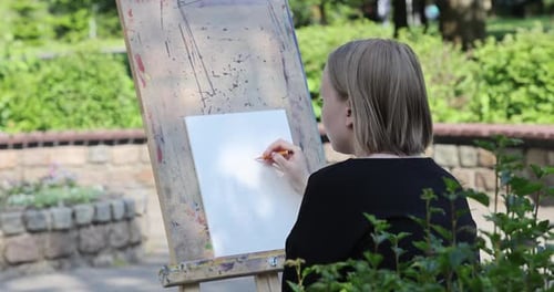 The young woman sketching a floral composition with a pencil