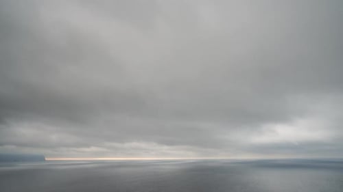 Timelapse Rainy Nimbostratus Clouds Moving in Bright Sunset Sky Over Stormy Sea Abstract Aerial