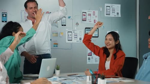 Enthusiastic Team Celebrates Project Success in the Office