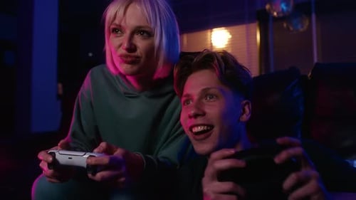 Young Adults Play Video Games Together at Home