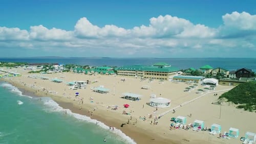 Aerial Over the Long Sandy Spit with a Beach and Azure Water on a Sunny Summer Day Waves Crashing to