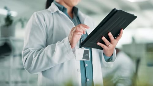 Woman Uses Tablet in Modern Laboratory