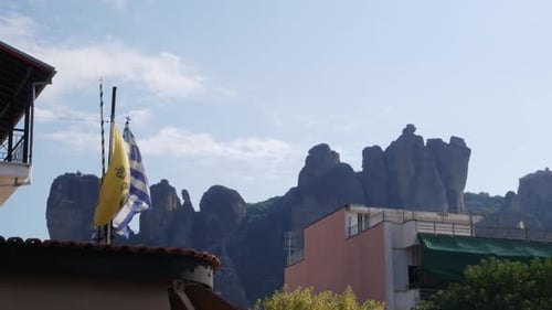 Greek Flags Waving Before Rock Formations