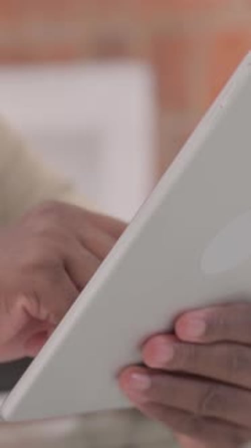 Close up of African Male Hand Using Tablet, vertical video