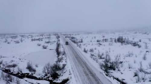 Aerial view of a car on a snowy road, Russia.