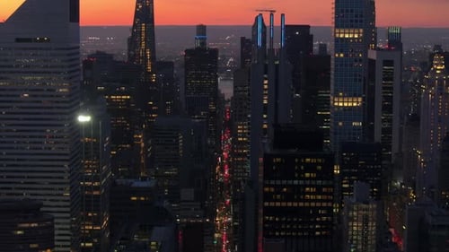 Orange and Blue Shades Paint the Sky As the Sun Sets Over Manhattan's Towering Skyscrapers Casting a
