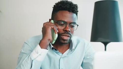 Man Talking By Mobile Phone in Office