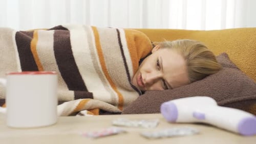 Woman with Cold Lying on Couch