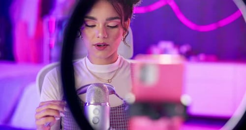 Woman, audio or influencer in home with microphone, neon or pleasure for social media