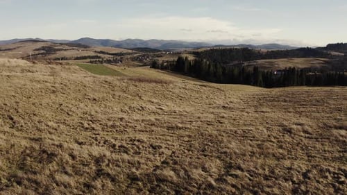 Autumnal Hillside and Carpathian Mountain Range in Aerial View