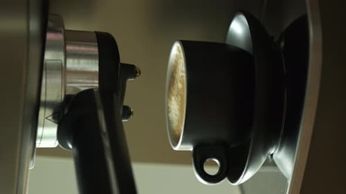 Preparing hot espresso coffee using a coffee machine. Making espresso coffee