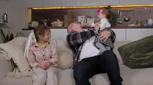 Happy Father and Two Little Daughter Bonding and Playing at Home