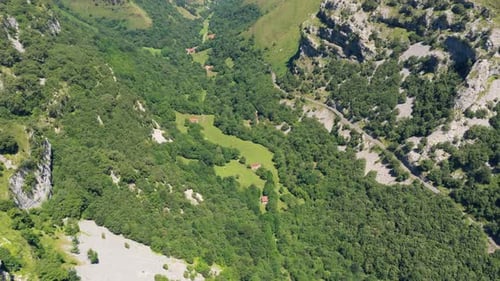 Aerial Drone View of Green Mountain Valley with Pastures and Forests
