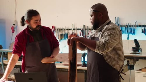 Men Collaborating on Woodworking Project in Workshop