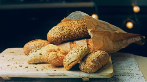Different Kinds of Fresh Bread on Wooden Table