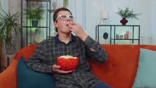 Young Man Watches Movie with 3D Glasses