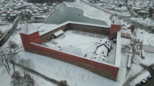 Aerial View of Medieval Fortress with Towers and Buildings in Courtyard Against Backdrop of Winter