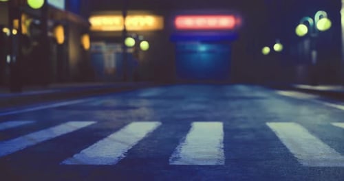 Nighttime Street with Glowing Lamps and Empty Crosswalk in Urban Setting