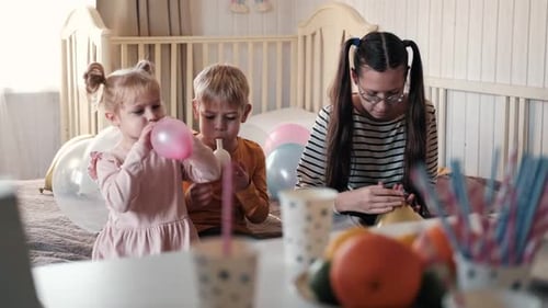 Children Blow Up Balloons for Birthday Celebration