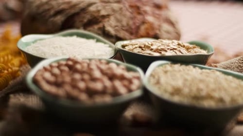 Rustic Bread and Grains Arranged on Tablecloth