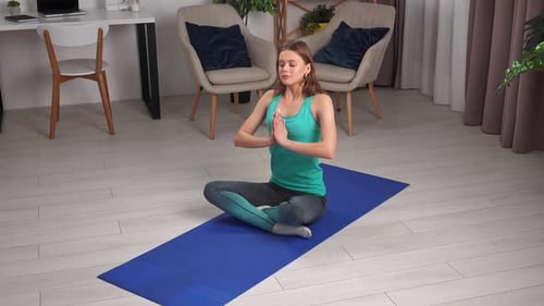 Young Woman Practicing Yoga at Home
