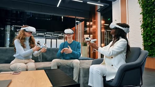 Business conference in VR in an office. Multiracial group of people using VR glasses and controllers