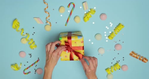 Hands Untie Present on Cheerful Background