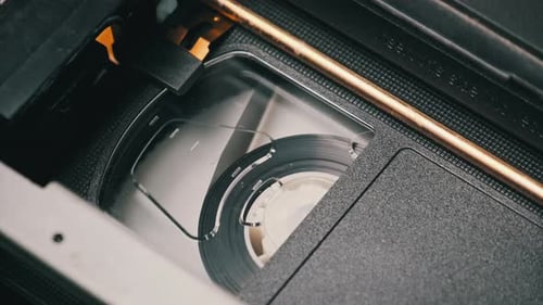 VHS Cassette is Played Inside a VCR Tape Recorder Top View