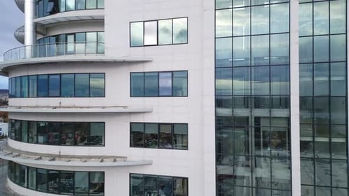 Business District Office Building with Wall Mirror with Cloudy Sky