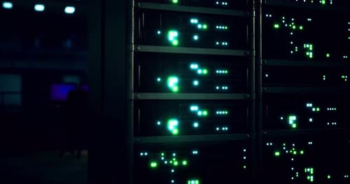 Illuminated Server Racks in a Modern Data Center at Night