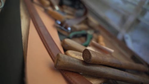Leatherworker workshop tools lying around on a table close up shot