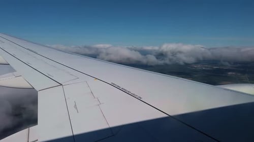 An Aerial View of a Beautiful CloudCovered Landscape Captured From an Airplane Window During Flight