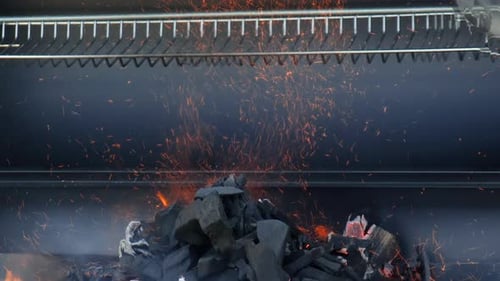 Charcoal Briquettes Burning in Flames in Grill