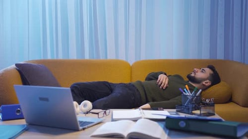 Man Relaxes on Couch After Finishing Work