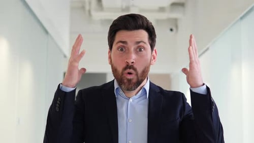 Shocked Adult Raising Hands in Office Space