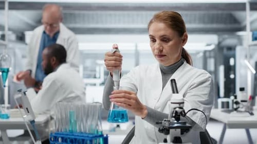 Focused Woman Working in Modern Science Laboratory