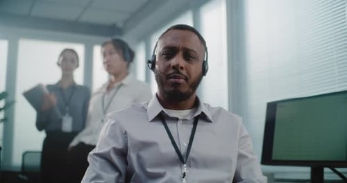 Man Wearing Headset Working in Bright Office